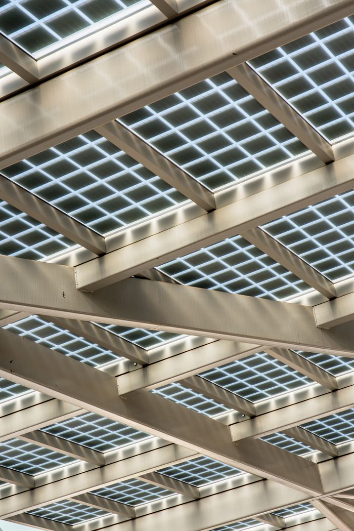 services-03 Abstract view of a modern solar panel structure with geometric patterns.