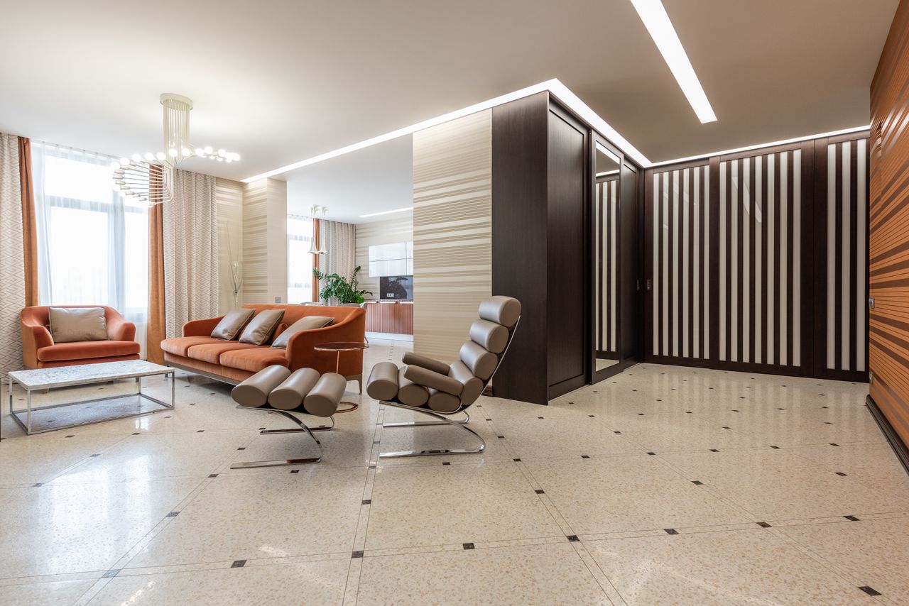 The Art of Drawing Readers In: Your attractive post title goes here Interior of modern flat with spacious corridor and comfortable seats in living room with kitchen counter in distance at home